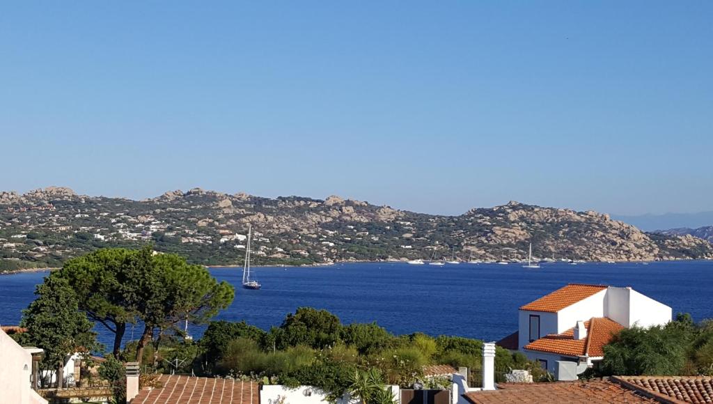 a view of a large body of water with a house at Holiday House La Rosa dei Venti in Palau