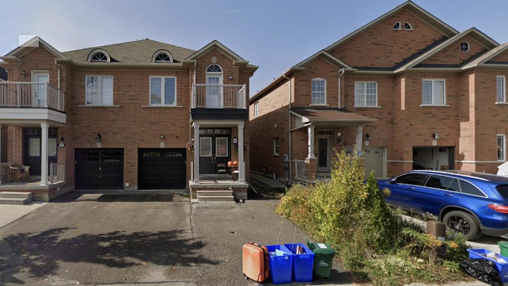 a blue car parked in front of a brick house at Luxury 3BR - 10 Min to Wonderland - Monthly Rental in Vaughan
