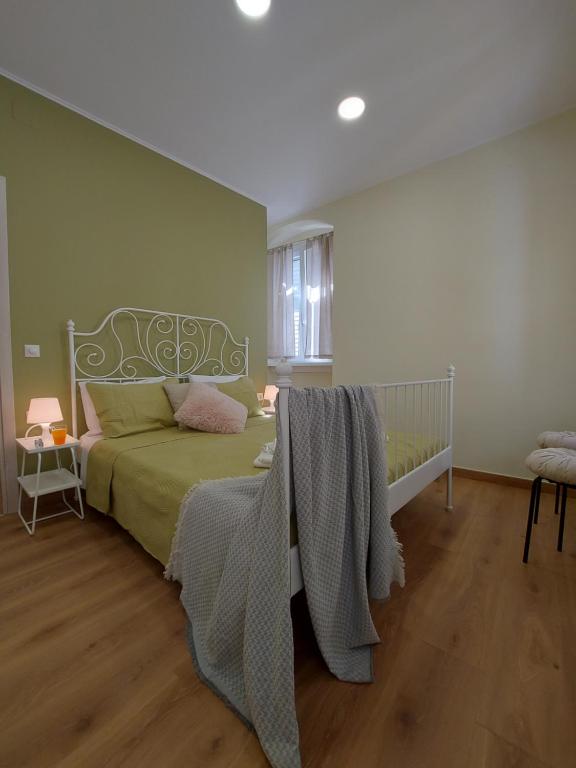 a bedroom with a bed with a blanket on it at La casetta di Emilia in Corfu Town