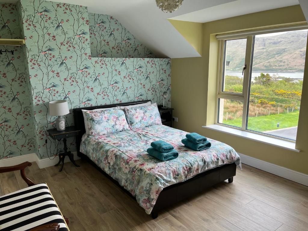a bedroom with a bed with two towels on it at Robins Nest in Ardara