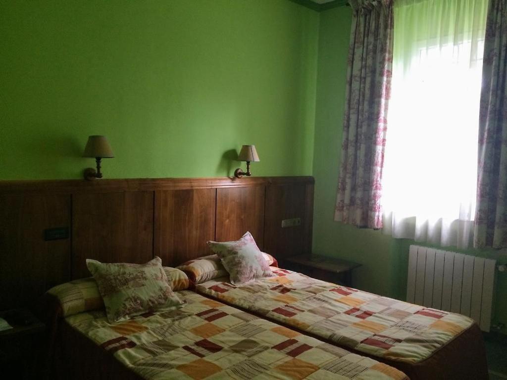Postel nebo postele na pokoji v ubytování Real Hotel