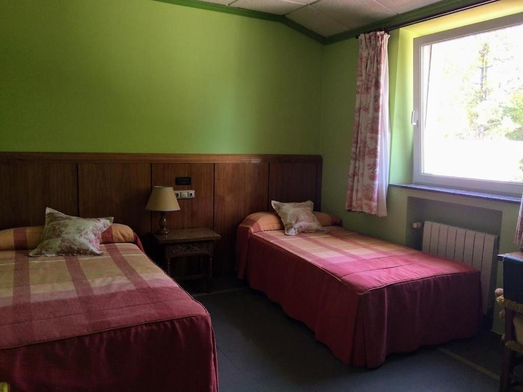 Postel nebo postele na pokoji v ubytování Real Hotel