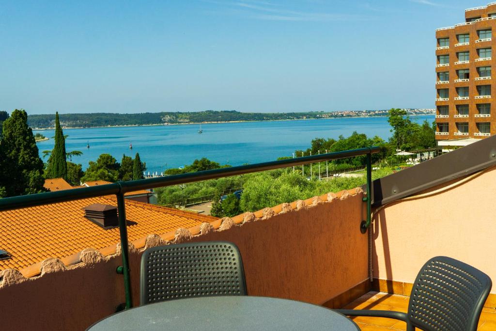 a balcony with chairs and a view of the water at Apartments Sara in Portorož