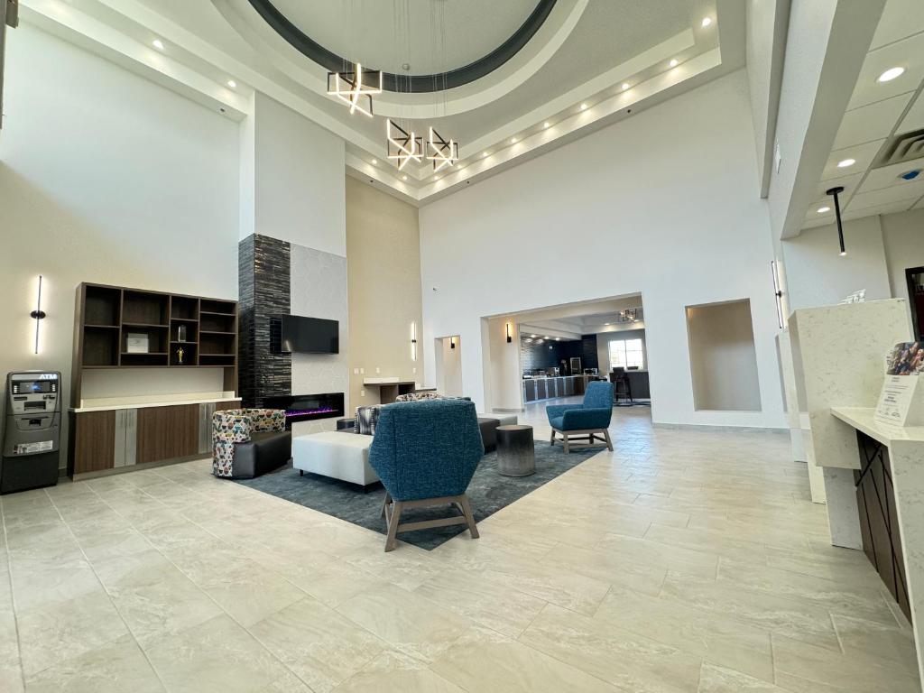 a lobby with a living room with a couch and chairs at La Quinta by Wyndham Allen at The Village in Allen