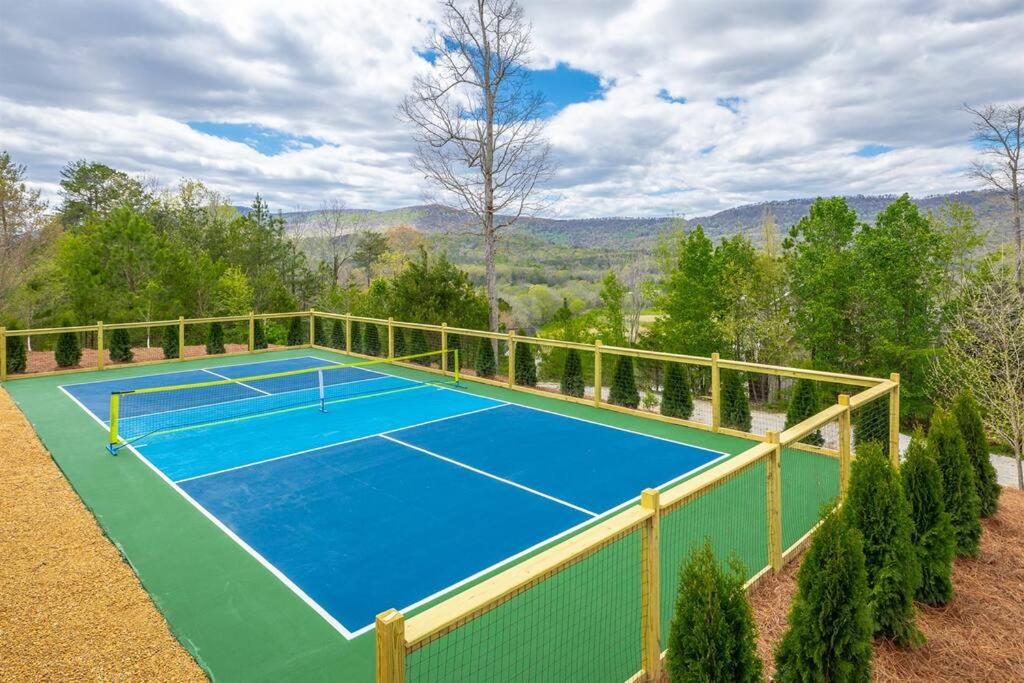 a tennis court on top of a house at Pickleball - Pool - Hot Tub - Gym - BBQ in Cenchat