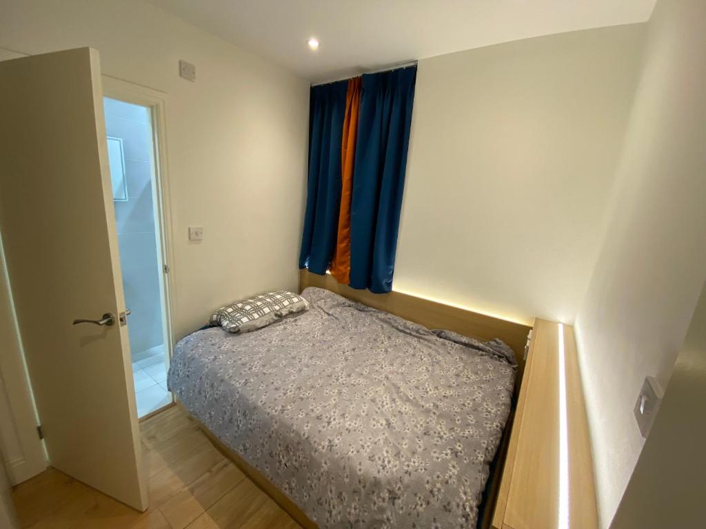 a small bedroom with a bed and a window at Not very quiet but Best location in London