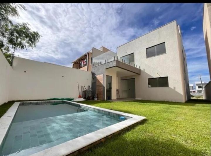 a house with a swimming pool in the yard at Ribeira House in Salvador