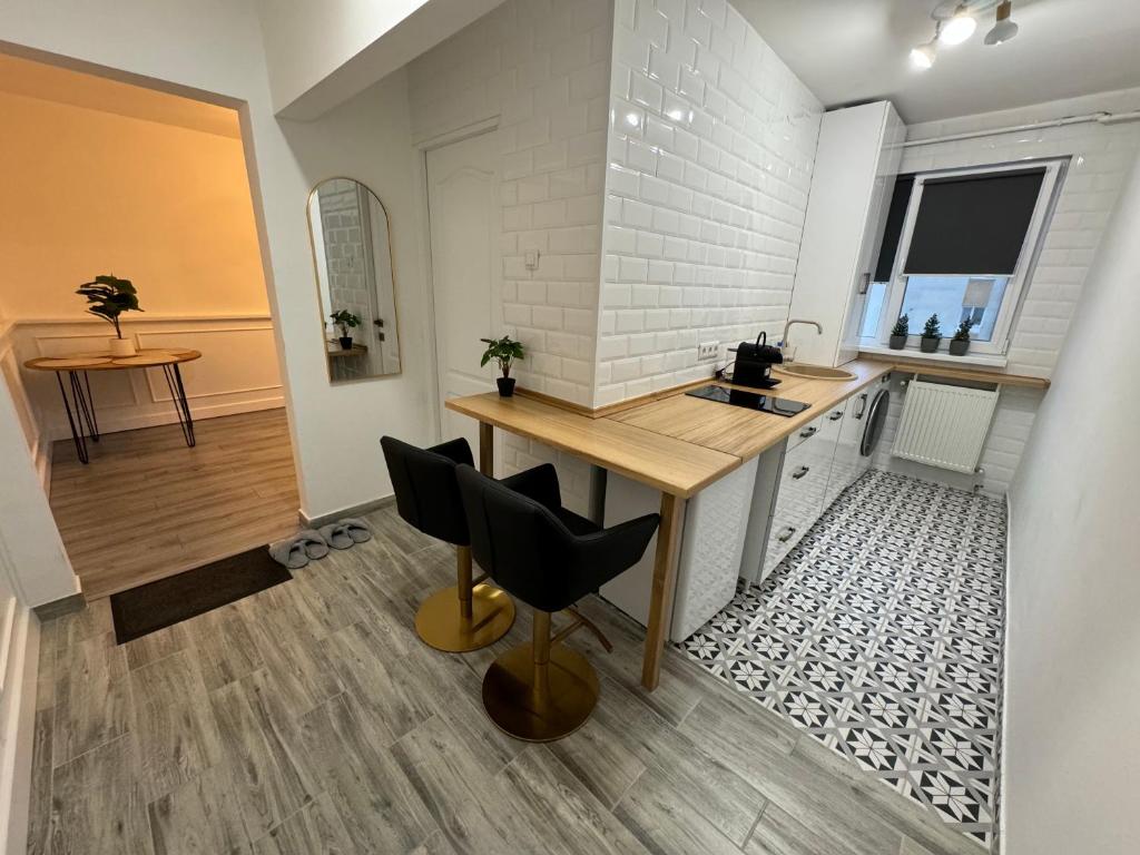 una cucina con tavolo in legno e piano di lavoro di Pinewood Apartment a Miercurea-Ciuc
