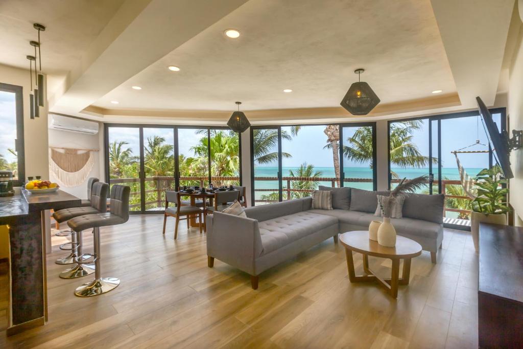 a living room with a couch and a table at Beachfront Hotel La Palapa - Adults Only in Holbox Island