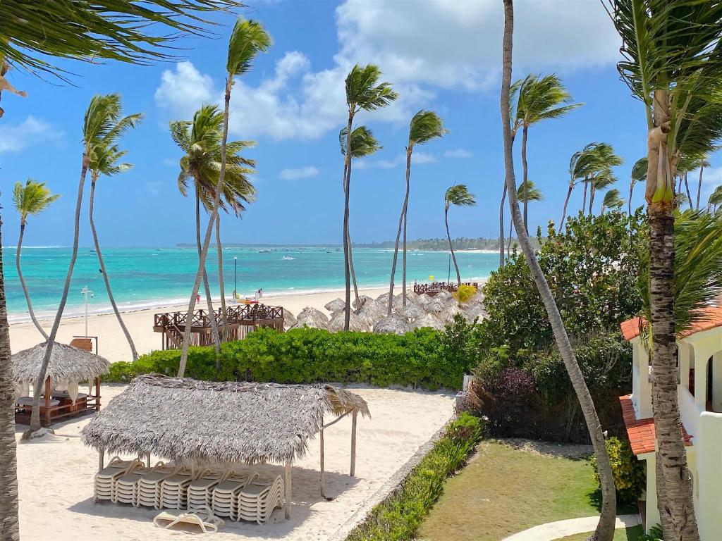 a view of the beach from the balcony of a resort at TROPICANA Sol CARIBBE del Mar STUDIOS & SUITES PUNTA CANA - playa BAVARO BEACH CLUB & SPA in Punta Cana