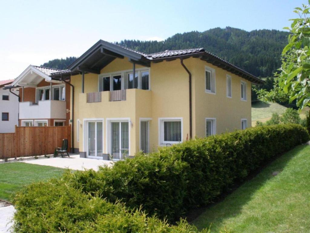 a large yellow house with a yard at Ferienhaus Gartentraum in Itter