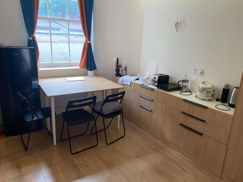 a kitchen with a table and two chairs and a desk at Not very Quiet but best location in London