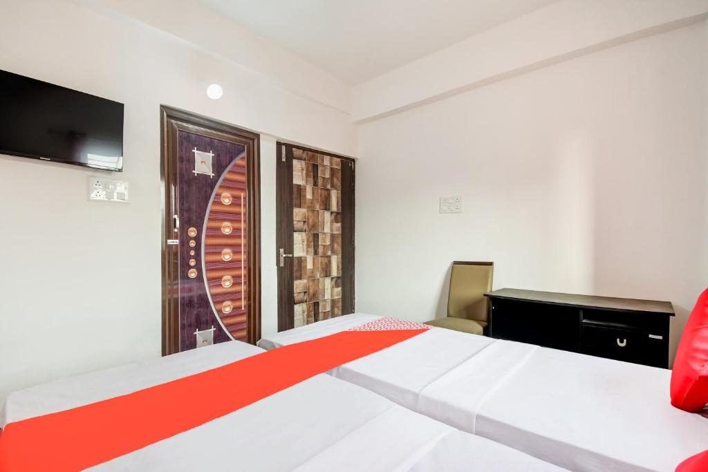 a bedroom with a white bed and a television at Flagship Hotel Creation Premium in Sānkchi