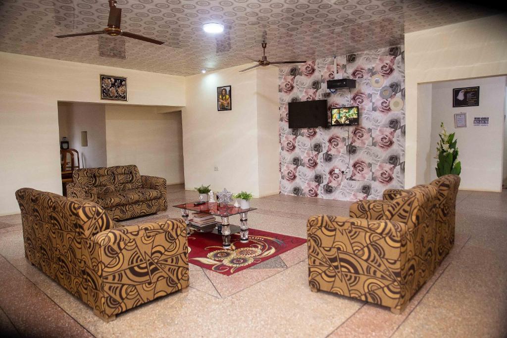 a living room with two chairs and a table at JaneChill Guest House in Accra