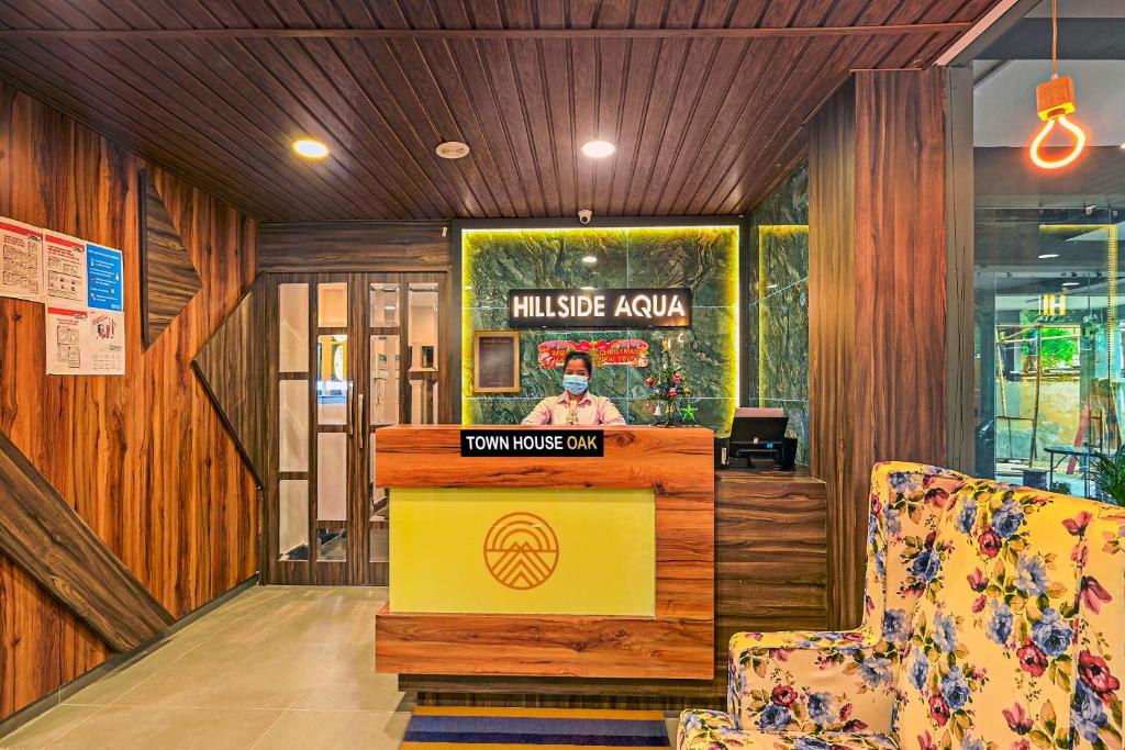 a lobby with a reception desk in a building at Townhouse OAK Hillside Aqua in Khandagiri