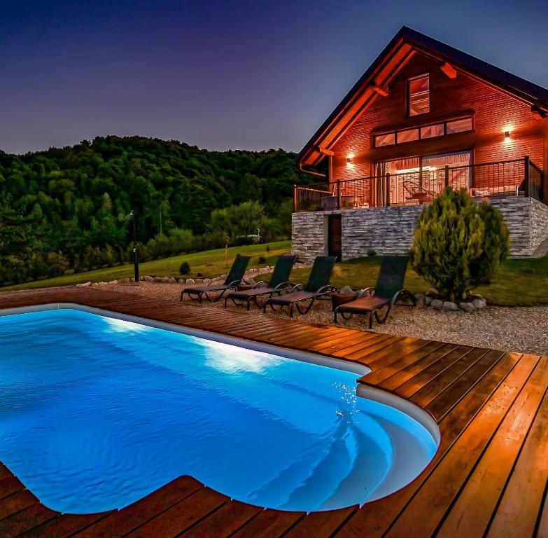 a house with a swimming pool in front of a house at Family friendly house with a swimming pool Ogulin, Gorski kotar - 22843 in Ogulin
