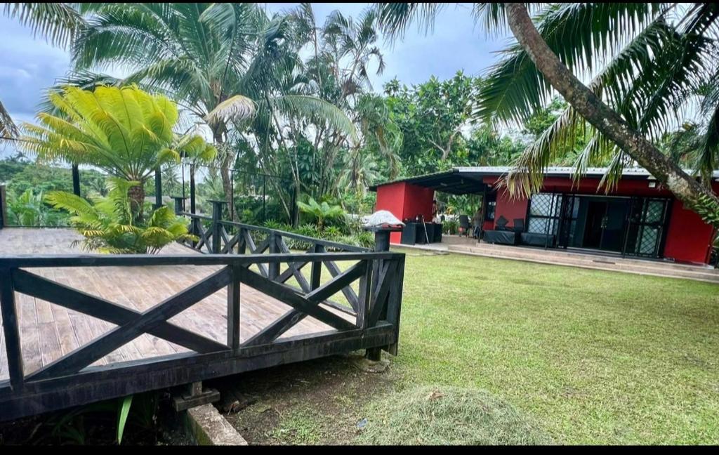 a house with a fence in front of a yard at Breath of Fresh air Suva Fiji in Suva