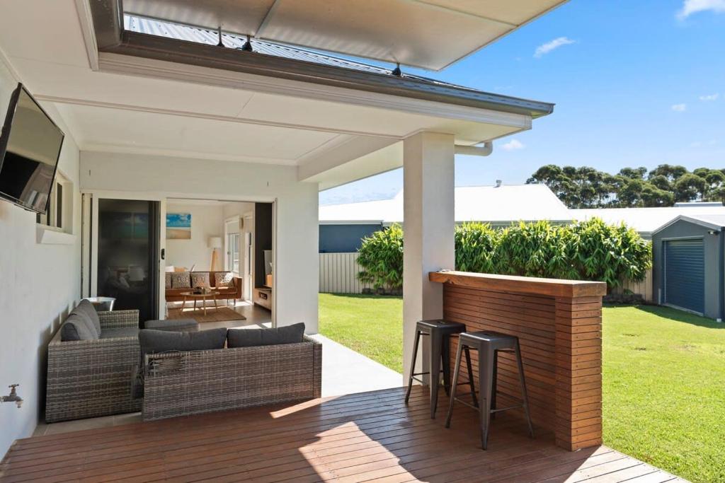 a patio with a bar and chairs on a house at LUXURY SEASIDE RETREAT / SUSSEX INLET in Sussex inlet