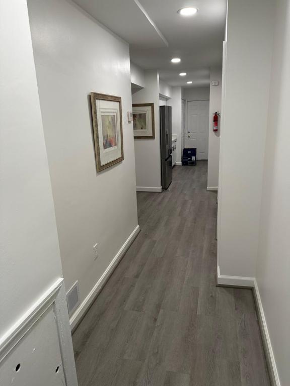 an empty hallway with white walls and wood floors at City access in Washington