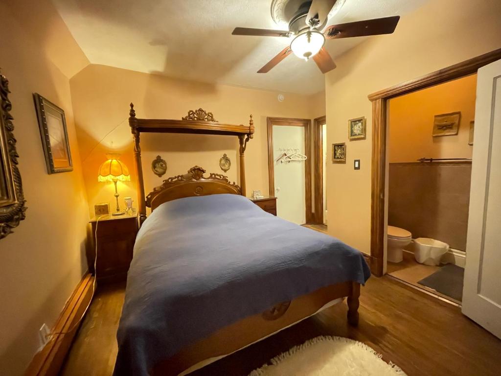 a bedroom with a bed and a ceiling fan at THE RED STAR ROOM B in Niagara Falls