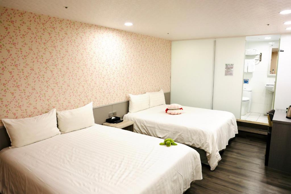 Postel nebo postele na pokoji v ubytování 歐法行旅 O Fun Hotel