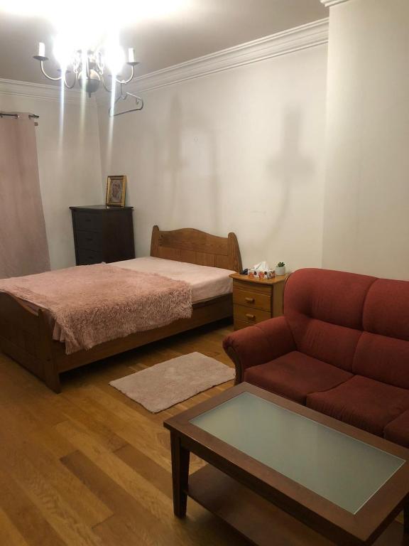 a living room with a bed and a couch at Apartamento Lisboa in Lisbon