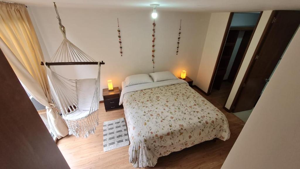 a bedroom with a bed and a hammock at La mejor habitacion privada del sector in Mosquera