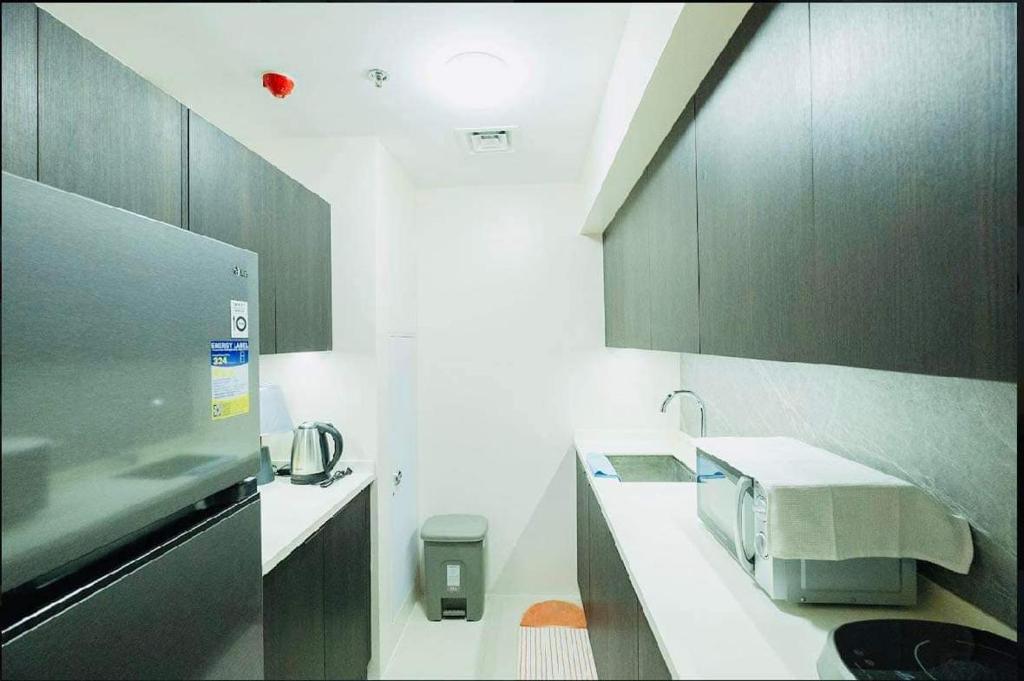 a kitchen with a sink and a microwave at Aeon Towers Davao Condominium in Davao City