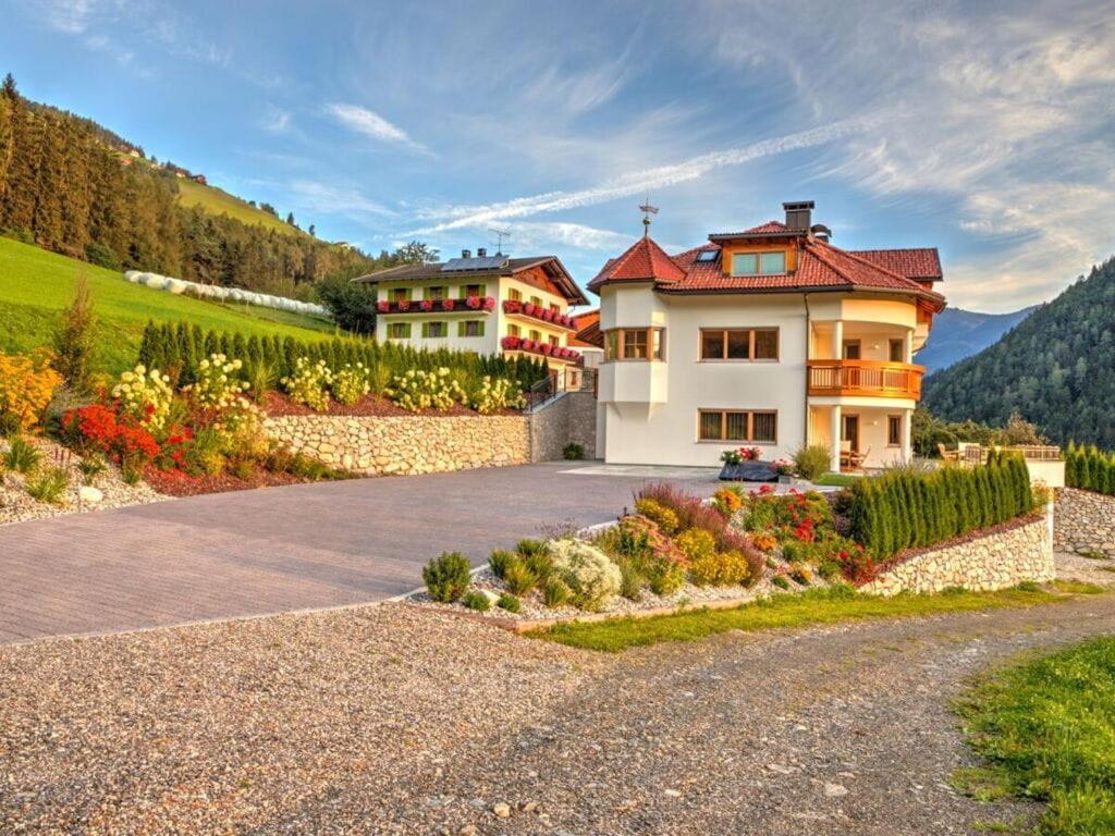a house on a hill with a driveway at Holiday apartment in St Lorenzen in Floronzo