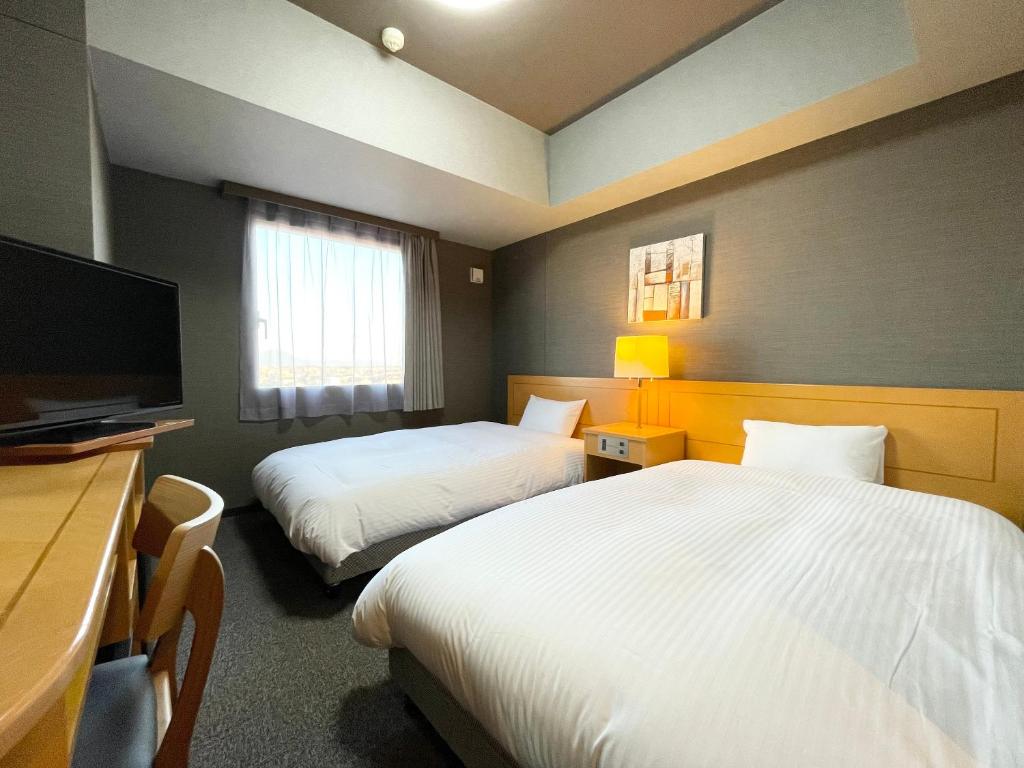 Postel nebo postele na pokoji v ubytování Hotel Route-Inn Yuki