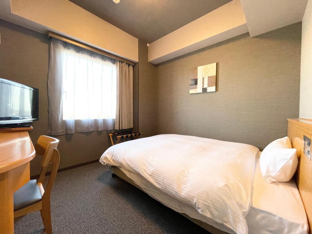 Postel nebo postele na pokoji v ubytování Hotel Route-Inn Yuki