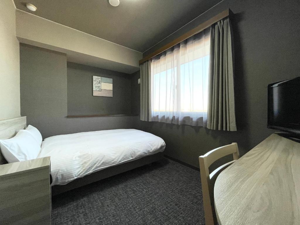 Postel nebo postele na pokoji v ubytování Hotel Route-Inn Yuki