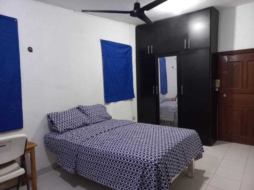 a bedroom with a bed and a black cabinet at CASA ALTABRISA in Mérida