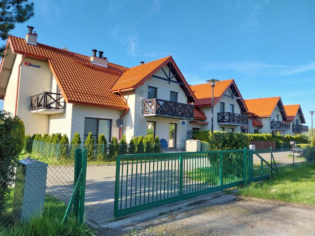 a row of houses with an orange roof at Aparatment Zatoka Pucka in Puck