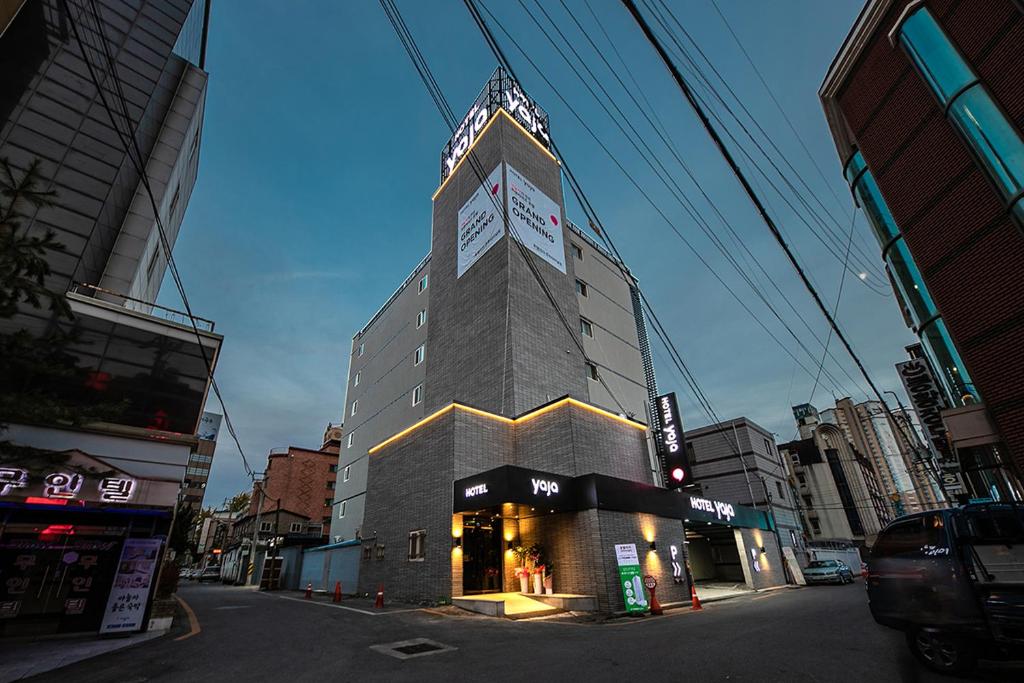 a tall building with a clock on top of it at Hotel Yaja Terminal Branch in Jeonju