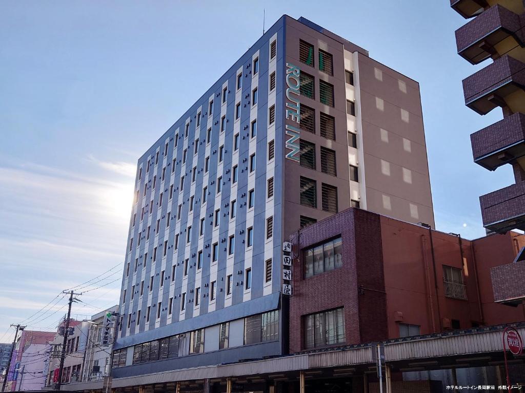 a tall building in the middle of a city at Hotel Route-Inn Nagaoka Ekimae in Nagaoka