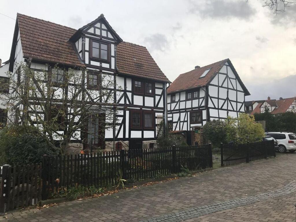 zwei schwarz-weiße Häuser mit einem Zaun in der Unterkunft Hansel and Gretel in Kassel