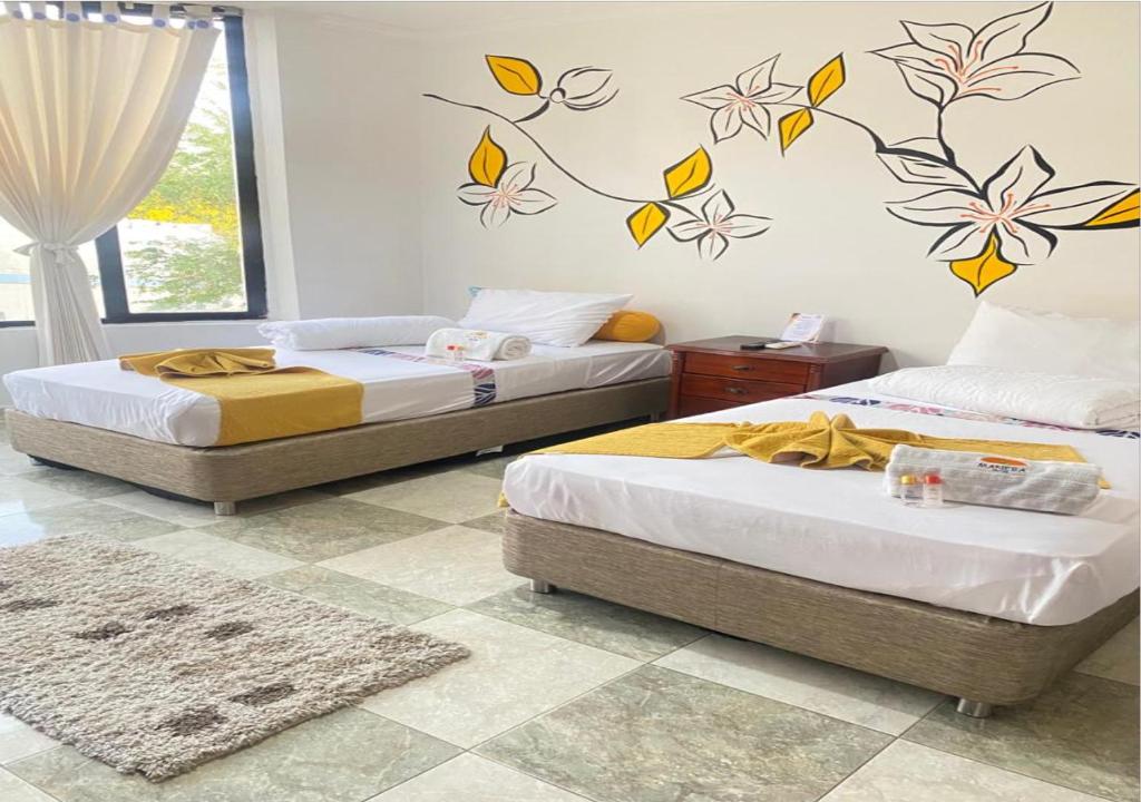 Postel nebo postele na pokoji v ubytování HOTEL MANÁ S.A.S.