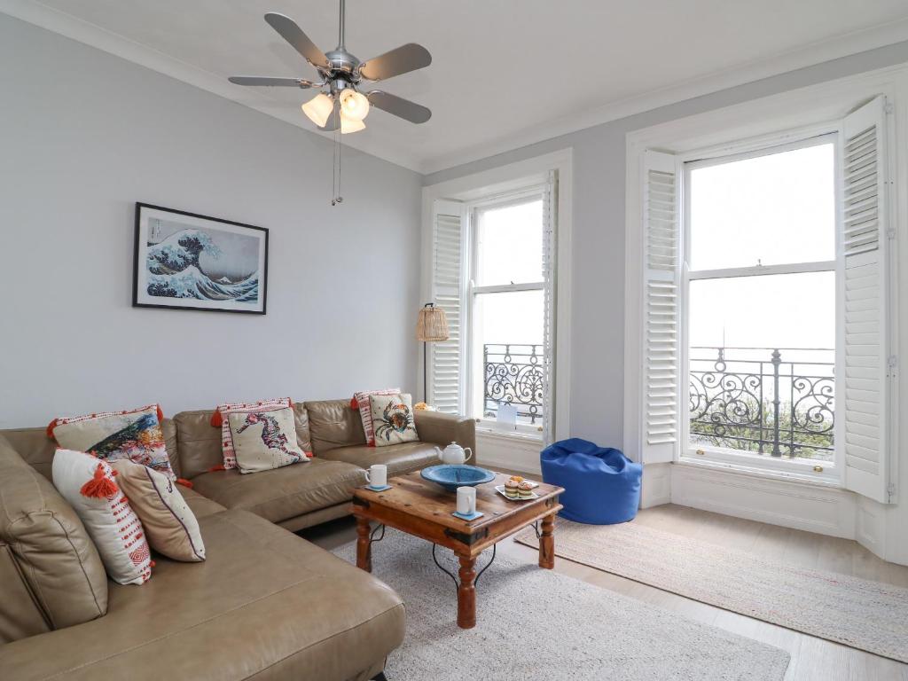 a living room with a couch and a table at Sunrise Apartment in Weymouth