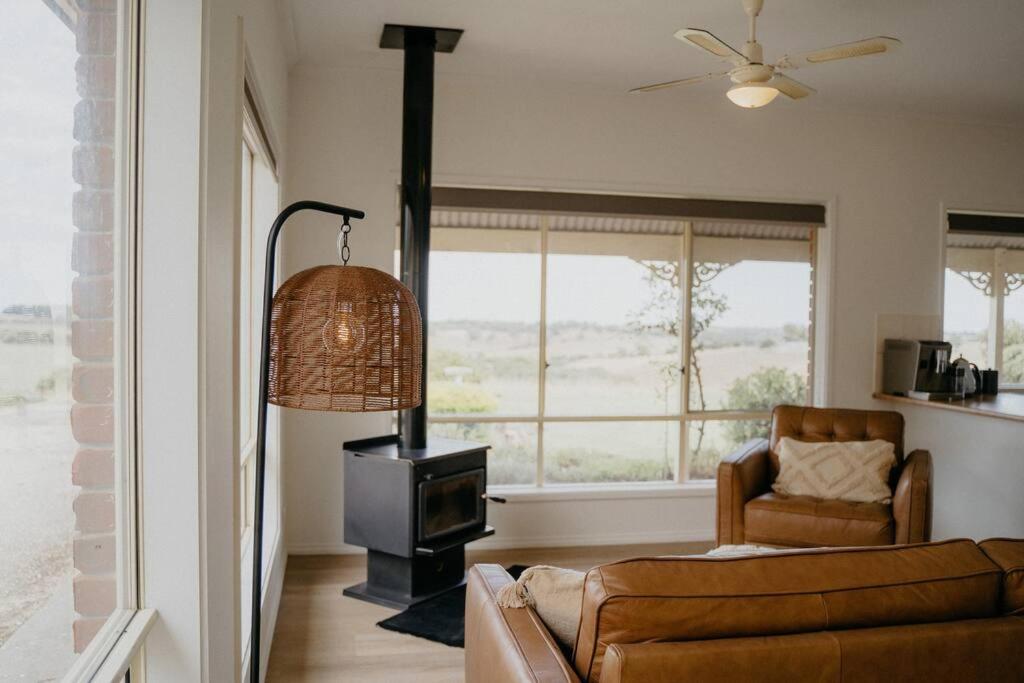 a living room with a couch and a stove at Adelaide Hills Country Paradise in Flaxley