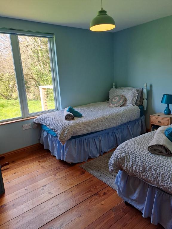 Postel nebo postele na pokoji v ubytování Helnoweth Lodge