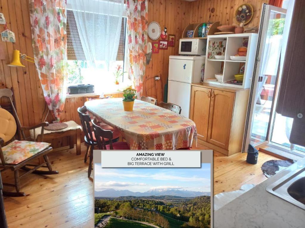 a kitchen with a table with a view of the mountains at House for nature lovers in Medvode