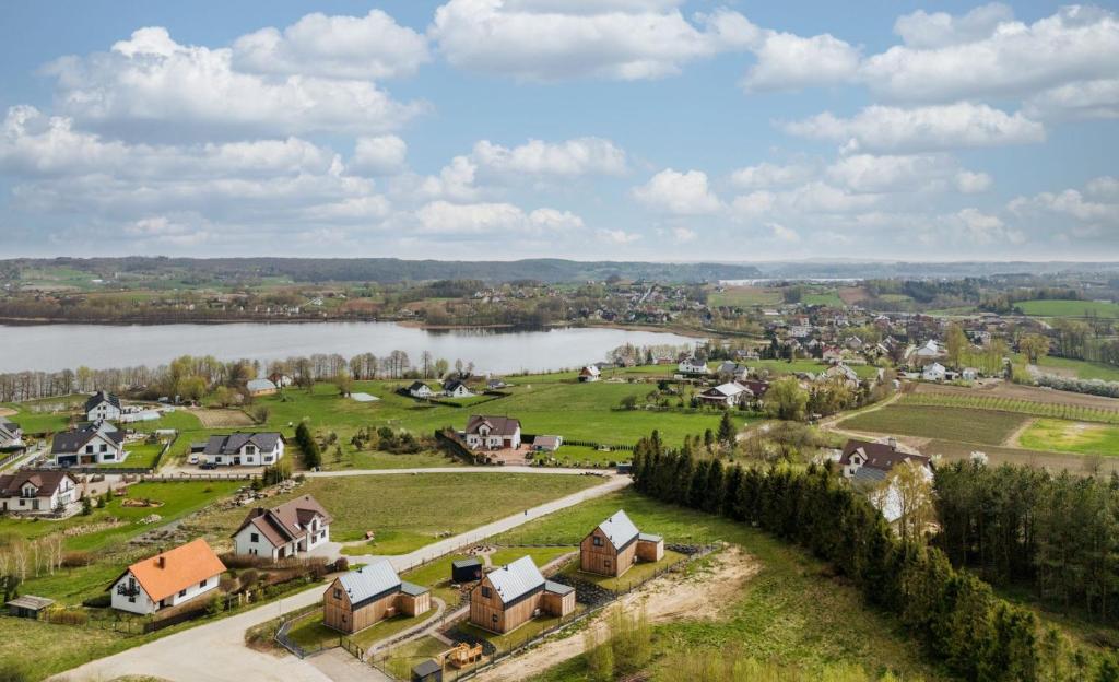 an aerial view of a small town with a lake at Garczovka - domki, jacuzzi, sauna in Garcz
