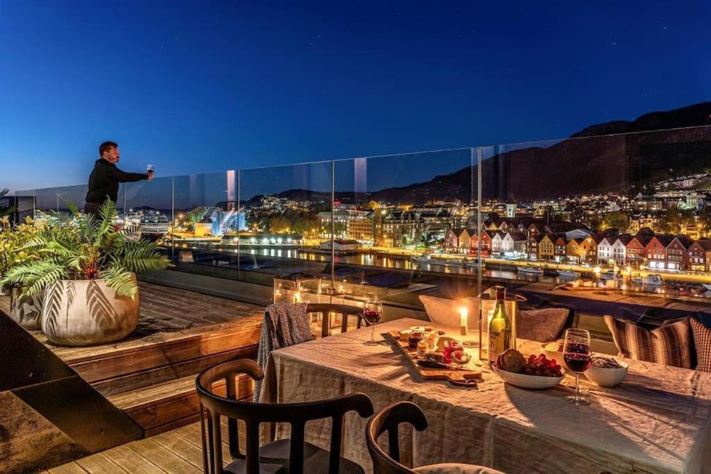 a man standing on the roof of a building at Exclusive Penthouse with Terrace in Bergen
