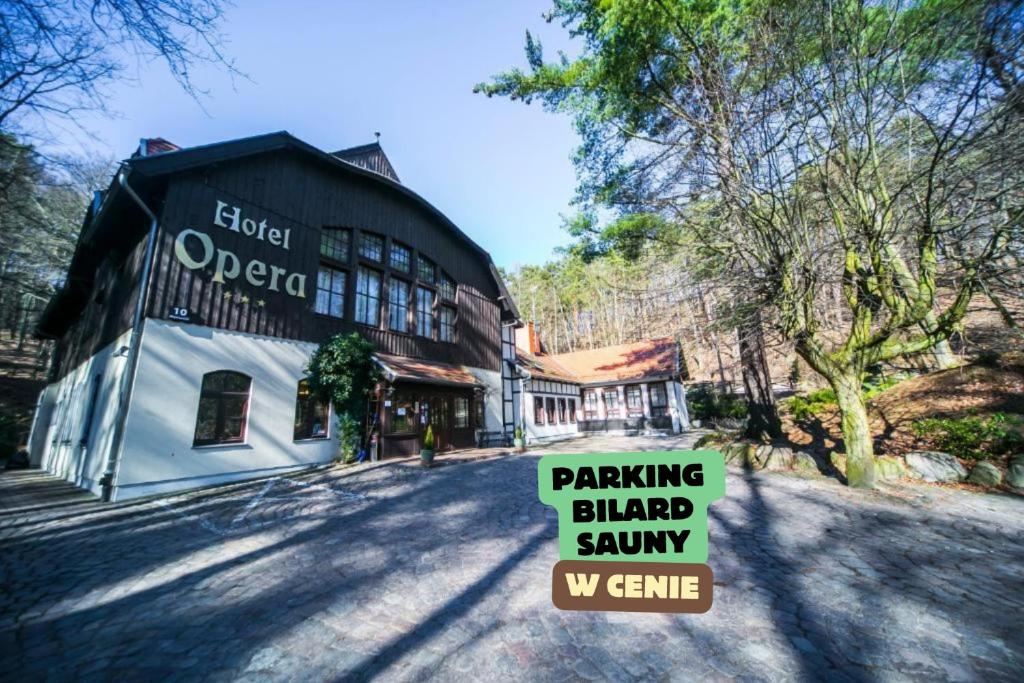 a building with a sign that reads parking blader savannawx crime at Hotel Opera in Sopot