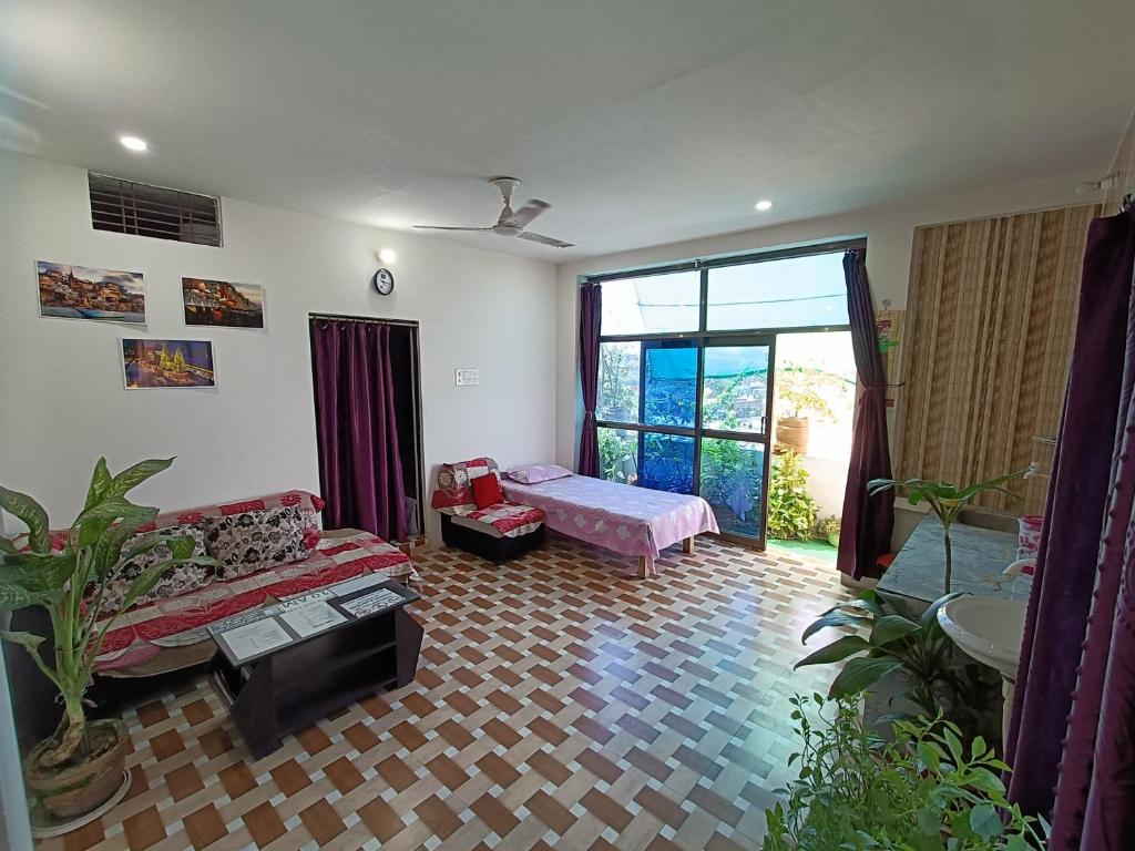 a living room with a couch and a bed at Green stay homestay in Rāmnagar