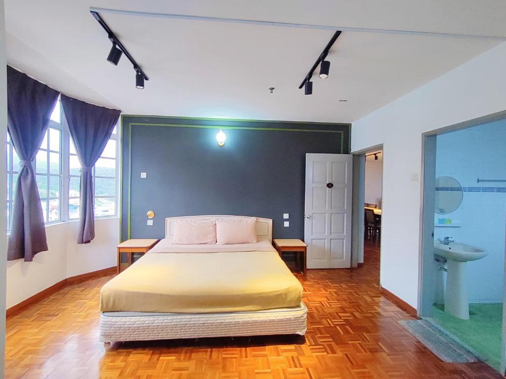 a bedroom with a bed and a bathroom at The Little Star Hotel & Studio at Star Regency Residence in Brinchang