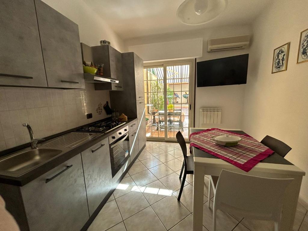 a kitchen with a table and a small table with a table at Casa Sophie in Oristano