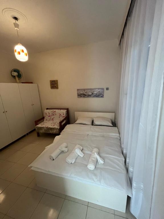 a bedroom with a bed with two slippers on it at ANASTASIA HOUSE in Sozopoli