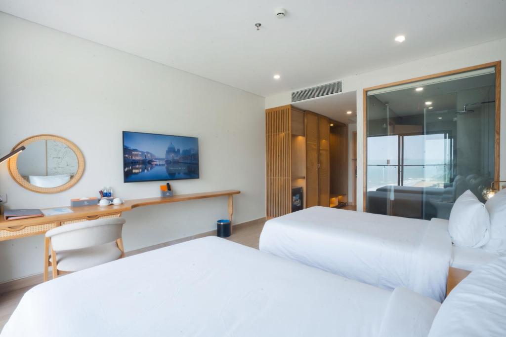 Postel nebo postele na pokoji v ubytování Seabird Hotel Thien Cam